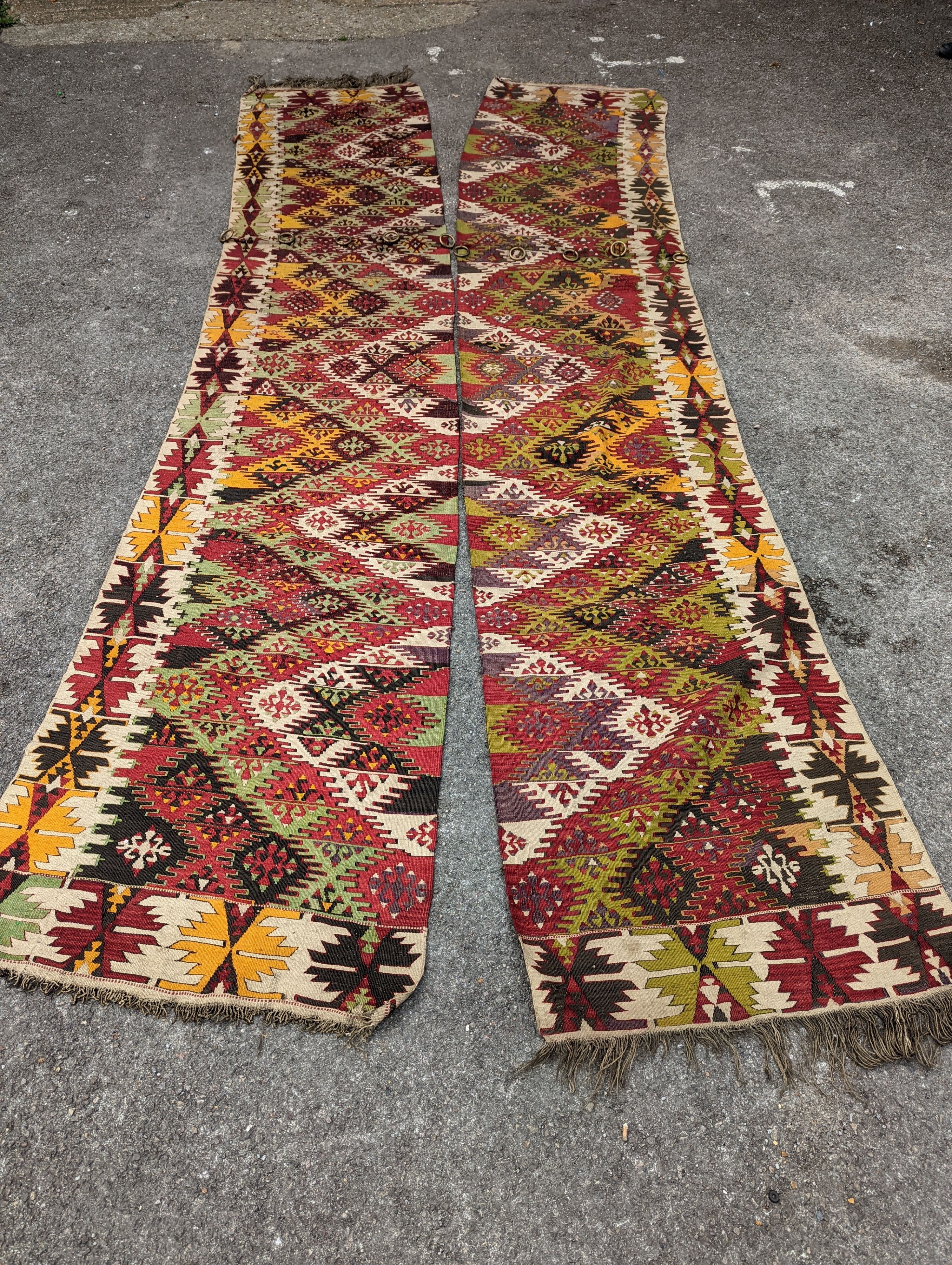 A Kelim polychrome flatweave carpet, cut centrally to create a pair of runners, each 410 x 85cm